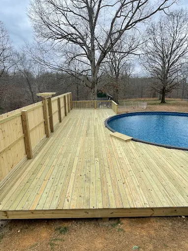 Custom pressure-treated pool deck with privacy fence built by Clay Sickel Construction